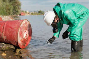 56450767 - environmentalist taking sample of polluted water