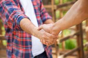 36272032 - construction workers shaking hands at site