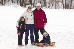 19385292 - family enjoying a day snow sledding