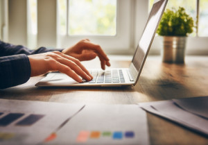 51914482 - businessman using laptop computer sitting working office.