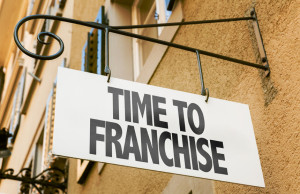 63486759 - time to franchise signpost on building background
