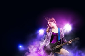 21358380 - young attractive rock girl playing the electric guitar