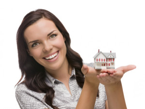 22706847 - mixed race woman holding small house isolated on white .