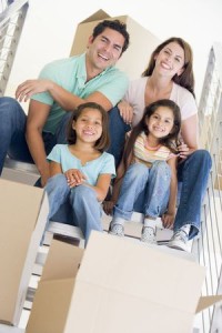 3487129 - family sitting on staircase with boxes in new home smiling