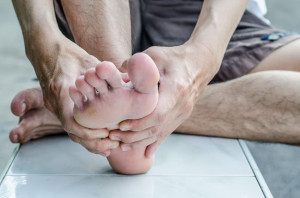 47923217 - man's hand being massaged a foot