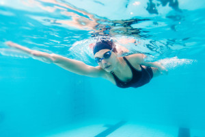 48869978 - female swimmer gushing through water in pool.