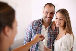 23148396 - cheerful couple getting keys of their new home