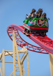 14681903 - peoples riding on a rollercoaster with blue sky in the background