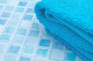 19628816 - blue bath towels on blue bathroom tiles