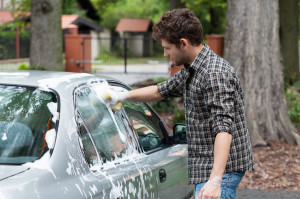 32823062 - young tall man washing his silver car
