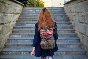 35752466 - student girl with a backpack climbing stairs. rear view