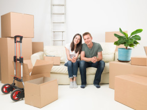 42861812 - happy couple sitting on sofa after moving in new house