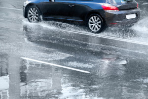 47255202 - flooded street with car and puddles after heavy rain