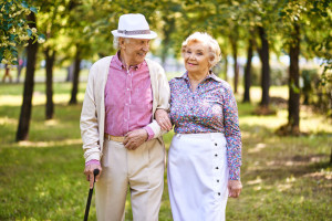 48109997 - happy seniors walking together in the park