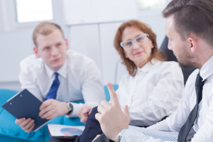 58408682 - three board members during meeting sitting in light office