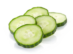 52935712 - fresh cucumber slices isolated on white background