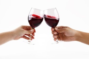 6335388 - two people toasting with wine glasses filled with red wine