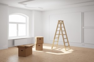 20588309 - empty room with ladder and cardboard boxes and hardwood floor