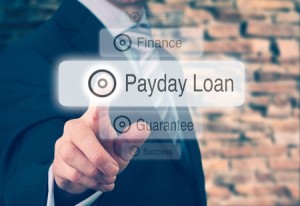 33562993 - businessman pressing a payday loan concept button.