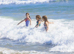 33595401 - kids playing in the ocean surf on vacation