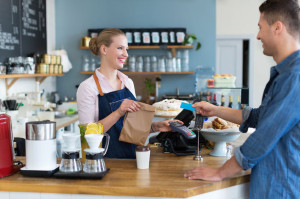 46982647 - barista serving customer in a coffee shop