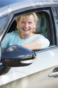 47928442 - portrait of smiling senior woman driving car