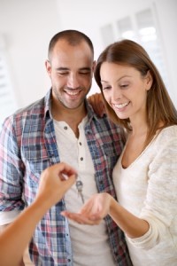 23148593 - cheerful couple getting keys of their new home