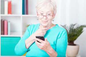 34799766 - older smiled lady and her new smartphone
