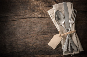 43659801 - vintage silverware with an empty tag on rustic wooden background