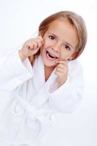 19981262 - little girl flossing - oral hygiene education in childhood