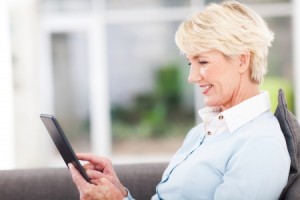 22889884 - pretty senior woman using tablet computer at home