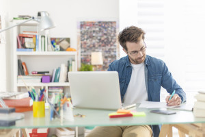 29907997 - young man working on a laptop indoors