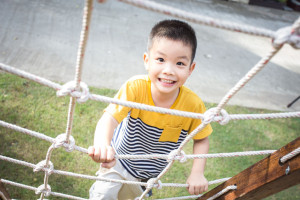 44637662 - little asian boy climbing rope obstacle activity on the playground