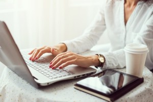 45720671 - woman working in home office hand on keyboard close up
