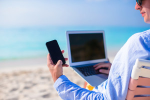 30122663 - close up telephone on background of computer at the beach