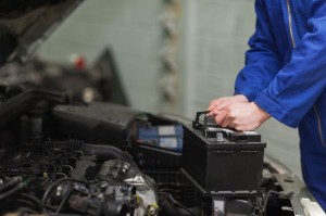 18109435 - male mechanic changing car battery