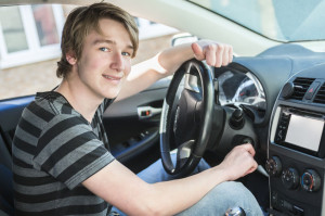 60042625 - a teenage boy and new driver behind wheel of his car