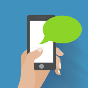 31848498 - hand holing smartphone with blank speech bubble for text.