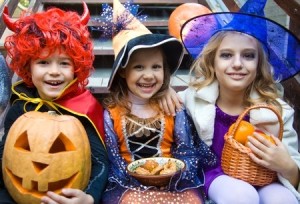 31928406 - children in halloween costumes with pumpkin fooled on holiday