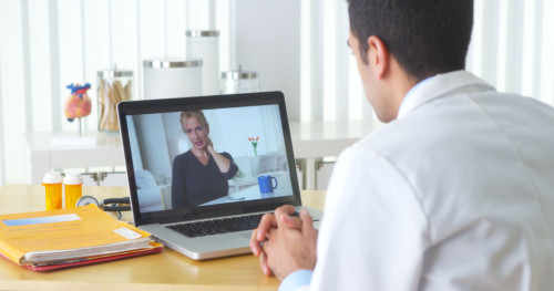 33804770 - mexican doctor video chatting with elderly patient