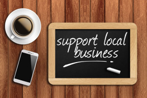 40817461 - coffee phone and chalkboard with make support local business words.