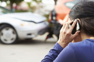 42310083 - female driver making phone call after traffic accident