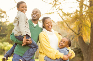 46685204 - portrait of a smiling young family laughing on an autumns day