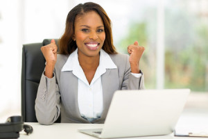 30664547 - excited african american businesswoman waving fists in office