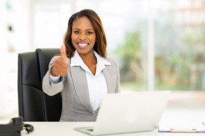 30685333 - cheerful young african businesswoman giving thumb up