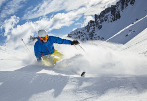 36301153 - skier skiing downhill in high mountains during sunny day.