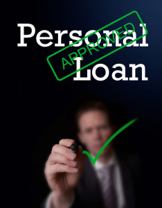 28172354 - an underwriter writing personal loan approved on a screen.