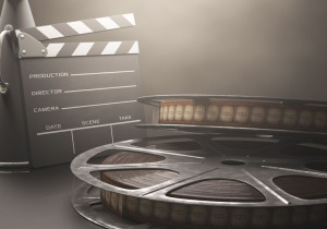 29825707 - clapperboard with rolls of film in the retro concept cinema.