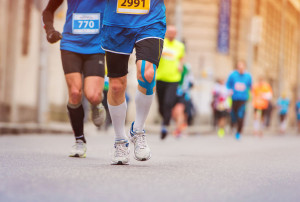 39333663 - unrecognizable young runner with injured knee at the city race