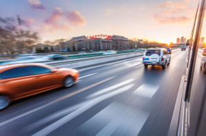 37907510 - car driving on freeway at sunset, motion blur